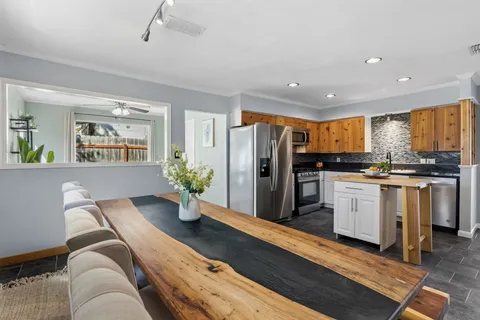 a kitchen with white cabinets and stainless steel appliances