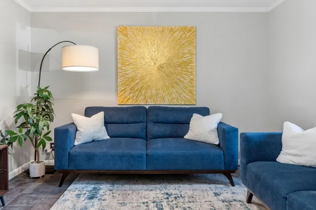 a living room with furniture and a potted plant