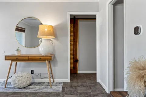 a view of a livingroom with furniture and a mirror