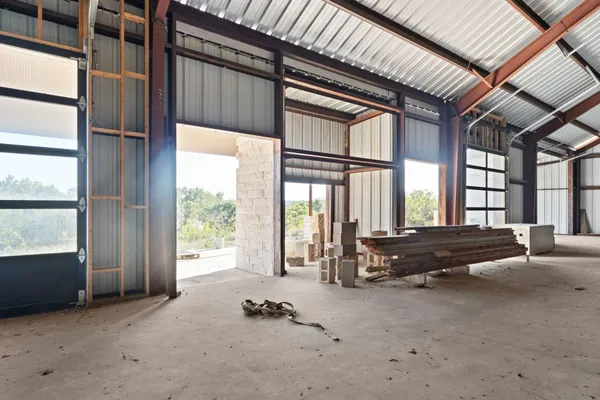 a living room with furniture and large windows