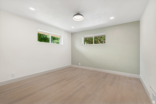 1010 West Maple Street Mapleton, UT 84664 - Photo 15 of 24 Spacious room featuring light wood-finish flooring, recessed lighting, and a modern semi-flush ceiling fixture