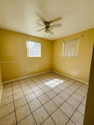 a view of a room with window and a ceiling fan