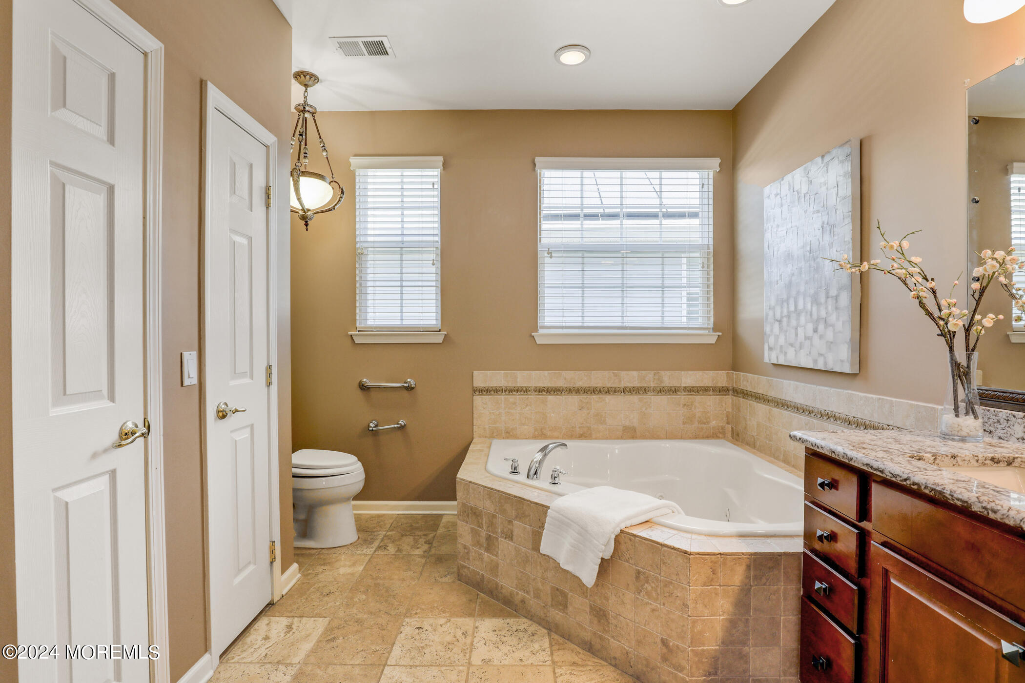 21 Hartack Road Manalapan, NJ 07726 - Photo 20 of 39 a bathroom with a granite countertop tub toilet a sink and a granite counter top