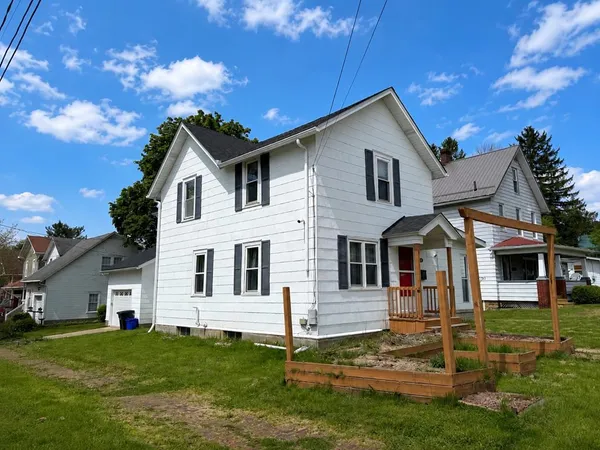 a front view of a house with a yard