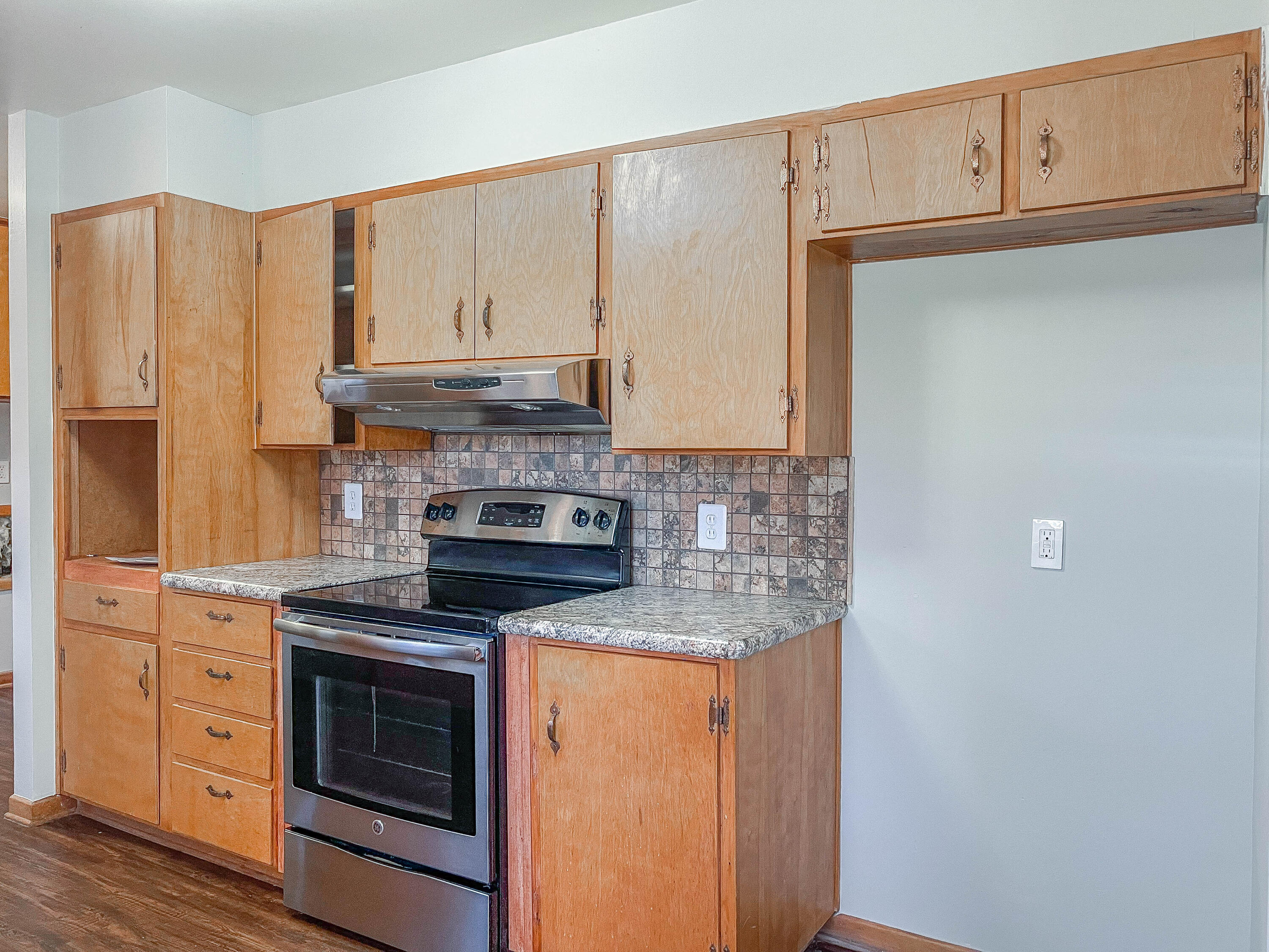 3419 53rd Street Lubbock, TX 79413 - Photo 5 of 11 a kitchen with granite countertop cabinets stainless steel appliances and a counter space