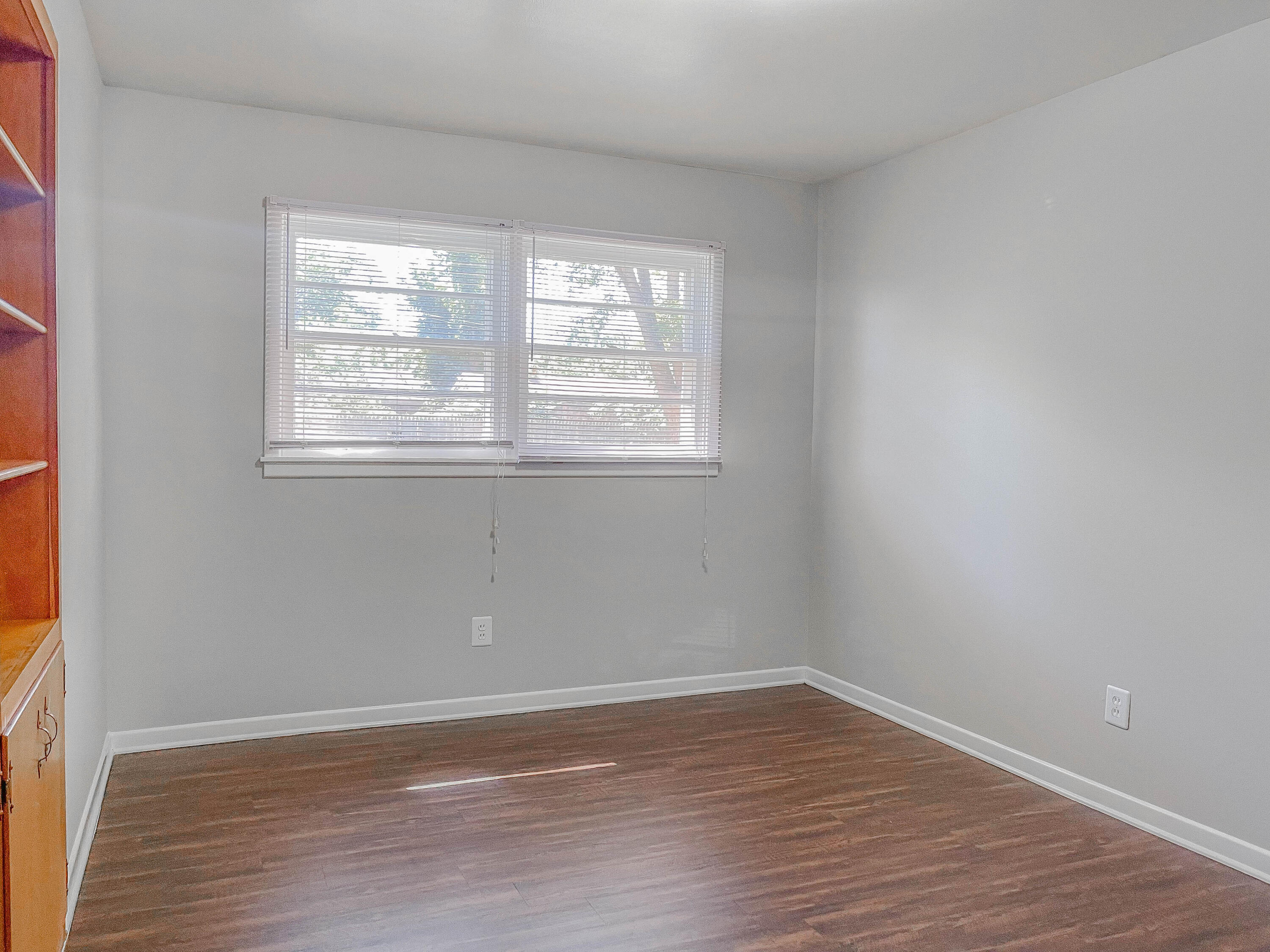 3419 53rd Street Lubbock, TX 79413 - Photo 7 of 11 an empty room with wooden floor and windows