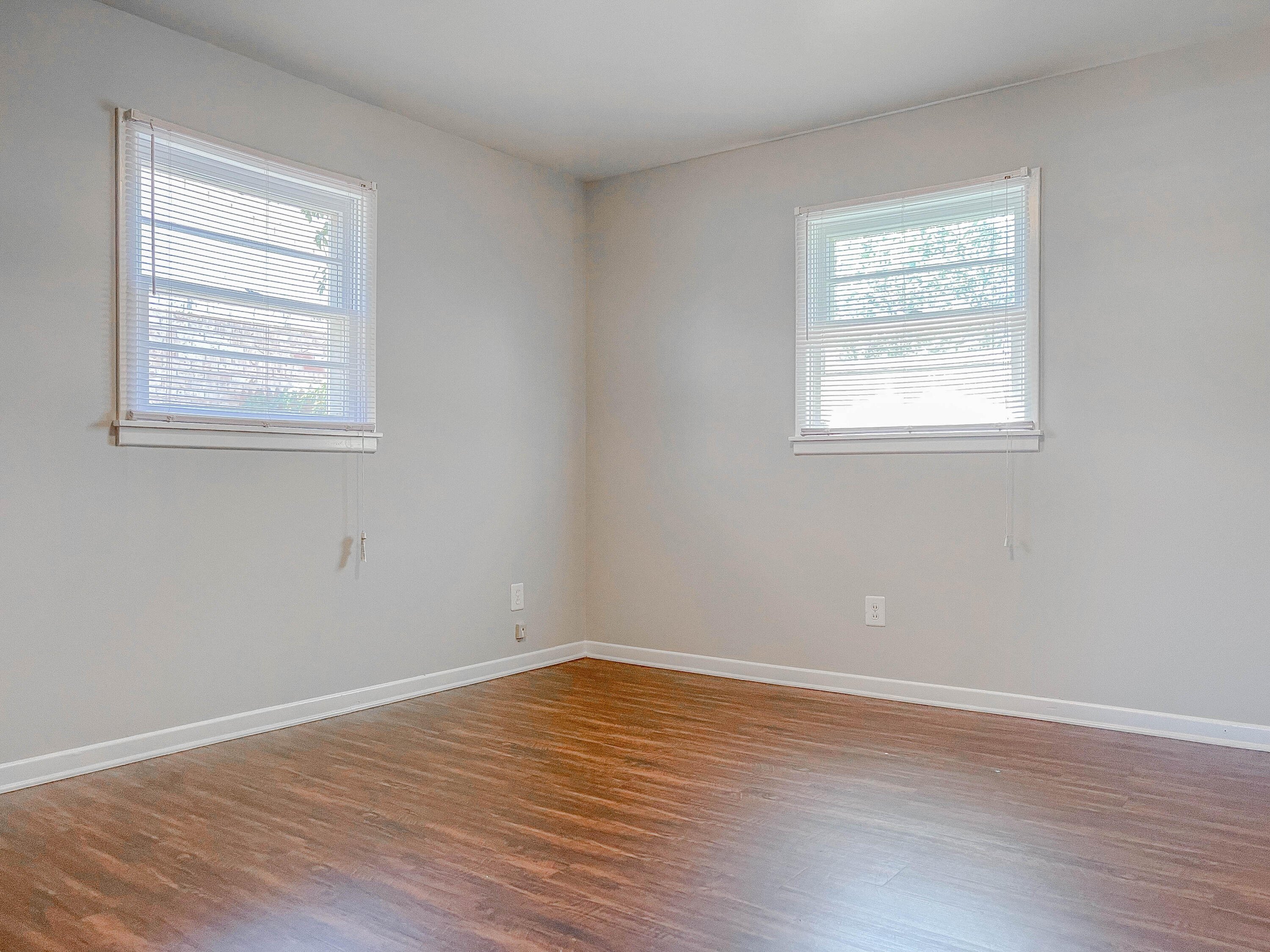 3419 53rd Street Lubbock, TX 79413 - Photo 9 of 11 a view of an empty room with wooden floor and a window