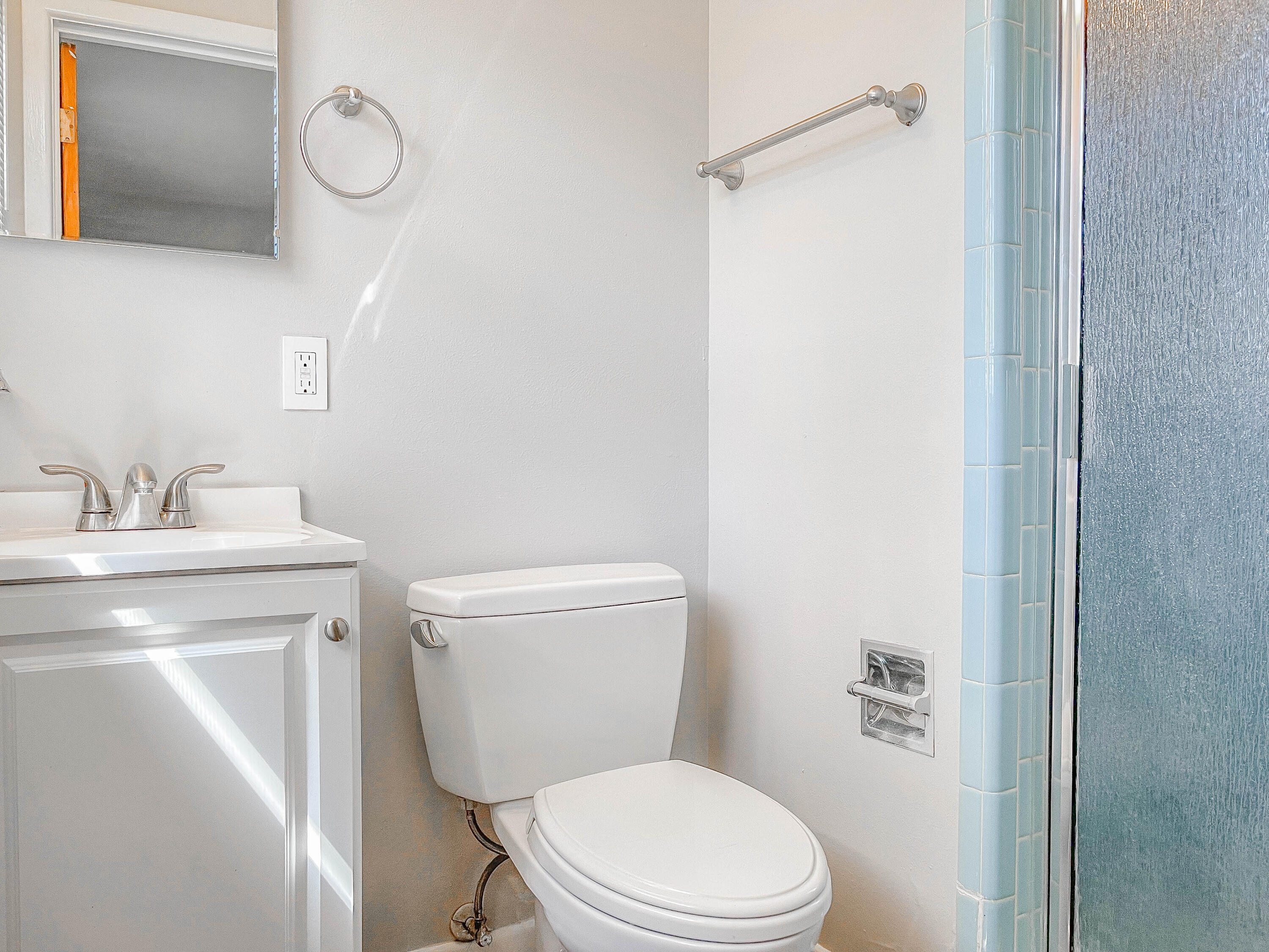 3419 53rd Street Lubbock, TX 79413 - Photo 10 of 11 a bathroom with a toilet a sink and mirror