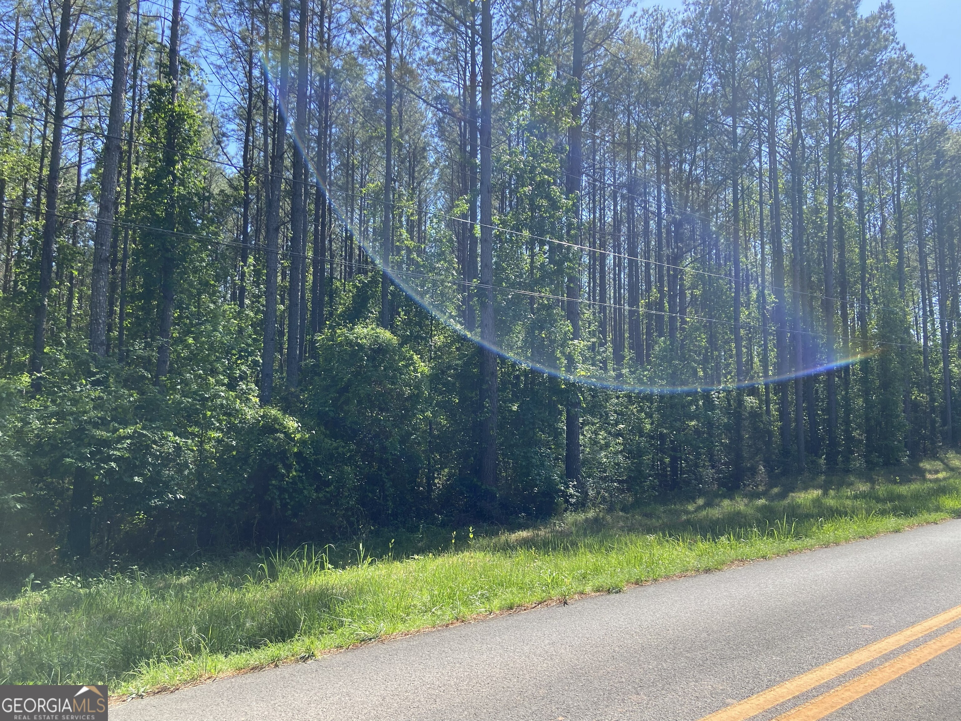 711 McCommon Road Forsyth, GA 31029 - Photo 2 of 5 a wooden fence with trees in the background
