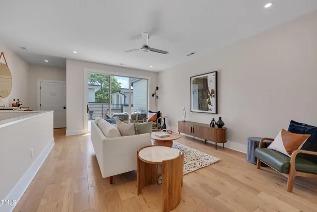 a living room with furniture and a wooden floor