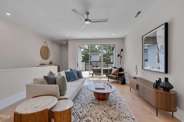 a living room with furniture a rug and a large window