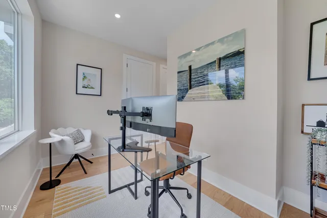 a workspace room with furniture and wooden floor
