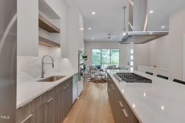 a kitchen with stainless steel appliances granite countertop a sink stove and cabinets
