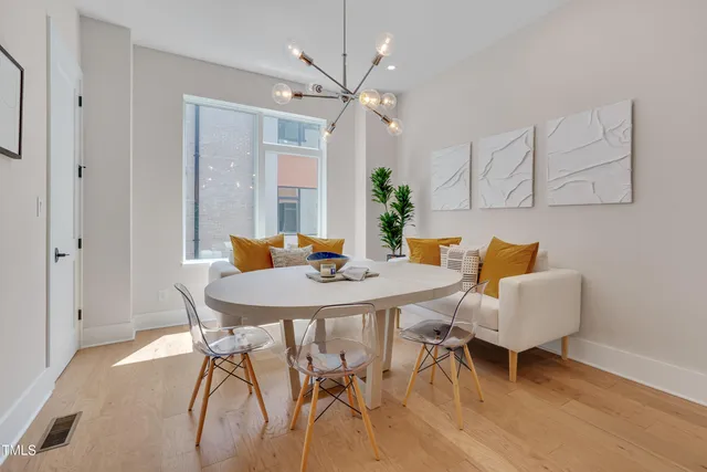 a view of a dining room with furniture and wooden floor