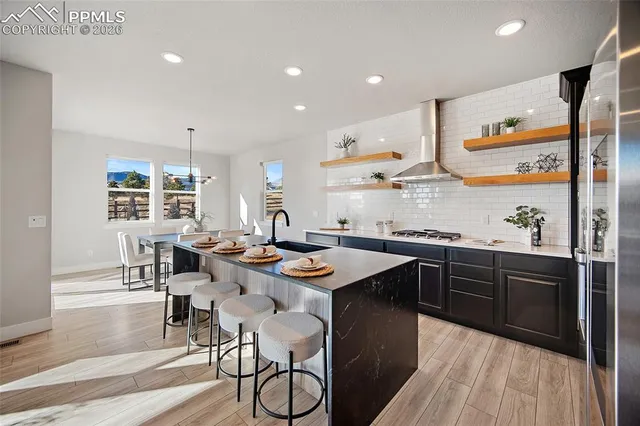 a kitchen with stainless steel appliances granite countertop a sink and a stove