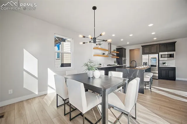 a view of a dining room with furniture window and wooden floor