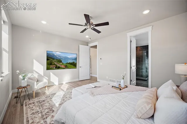 a bedroom with a large bed and a chandelier