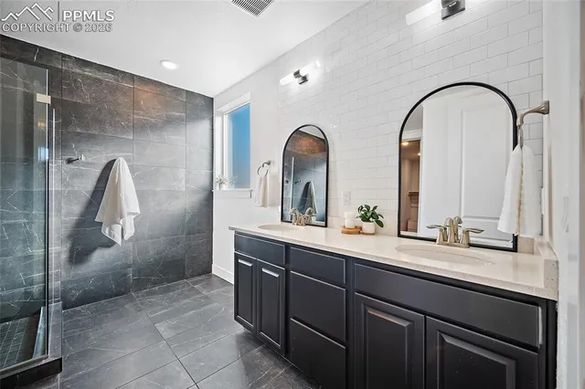 a bathroom with a double vanity sink and mirror