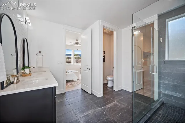 a spacious bathroom with a double vanity sink and a mirror