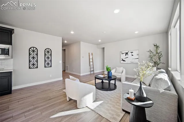 a living room with furniture and a chandelier