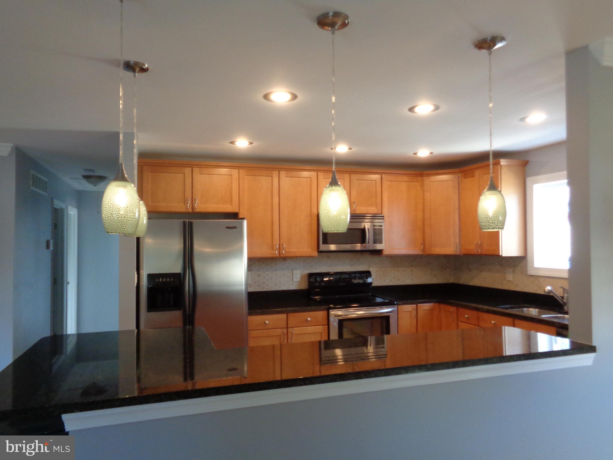 246 Arundel Road Pasadena, MD 21122 - Photo 4 of 27 Rich maple cabinetry and granite countertops