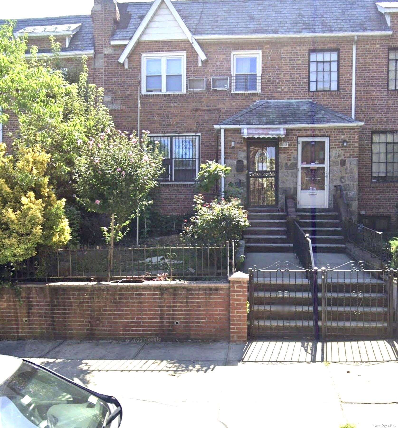 a view of a brick house with a yard