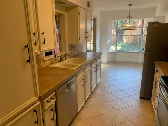 a kitchen with stainless steel appliances a sink and a refrigerator