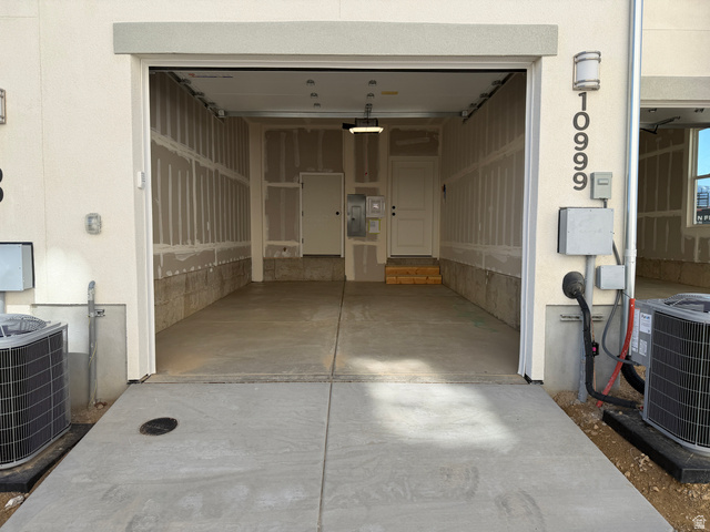 10999 South Freestone Road, Unit 111 South Jordan, UT 84009 - Photo 9 of 13 Garage featuring electric panel and driveway