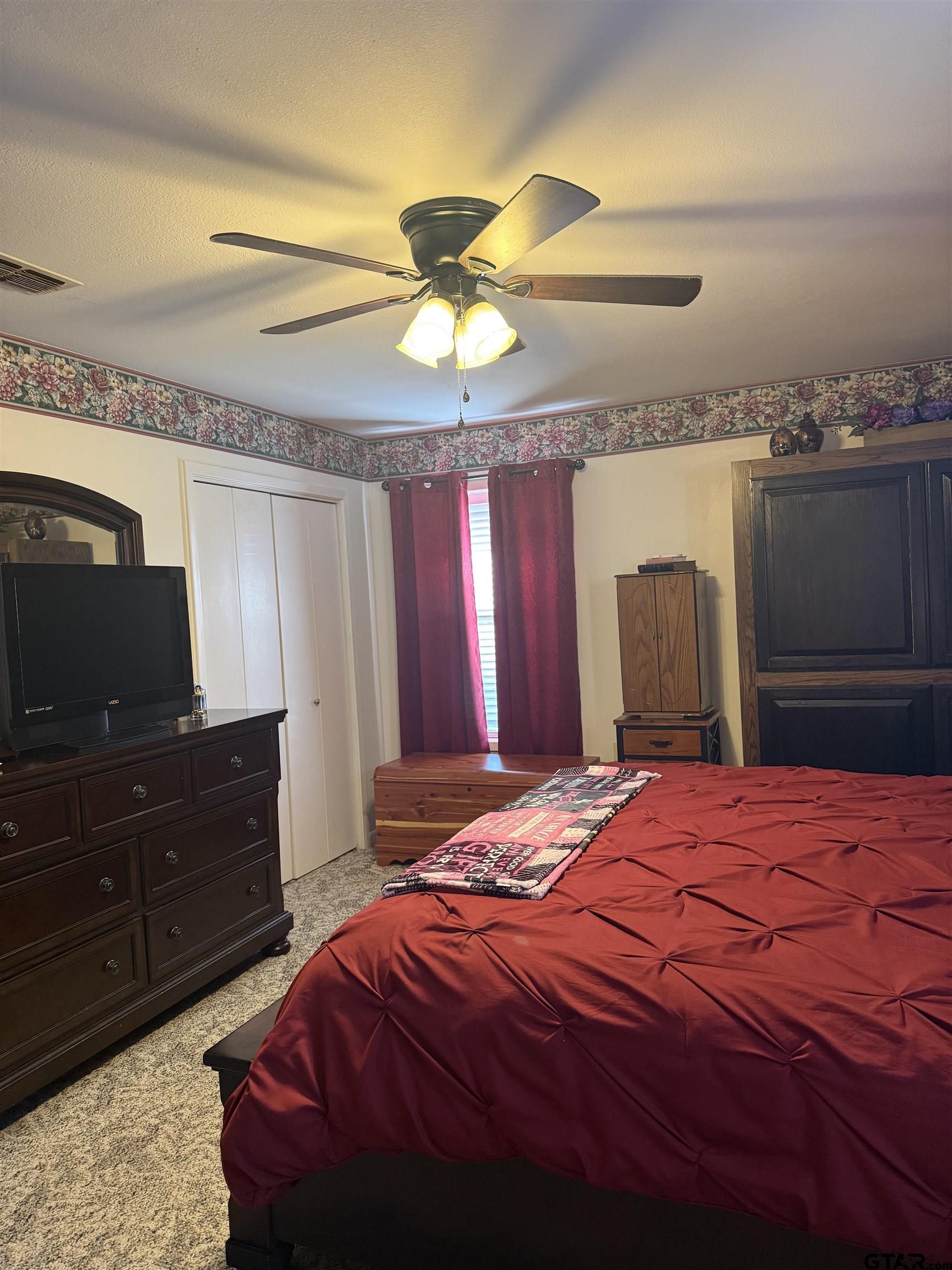 22571 Waterview Circle Flint, TX 75762 - Photo 23 of 41 a bedroom with a bed and a flat screen tv