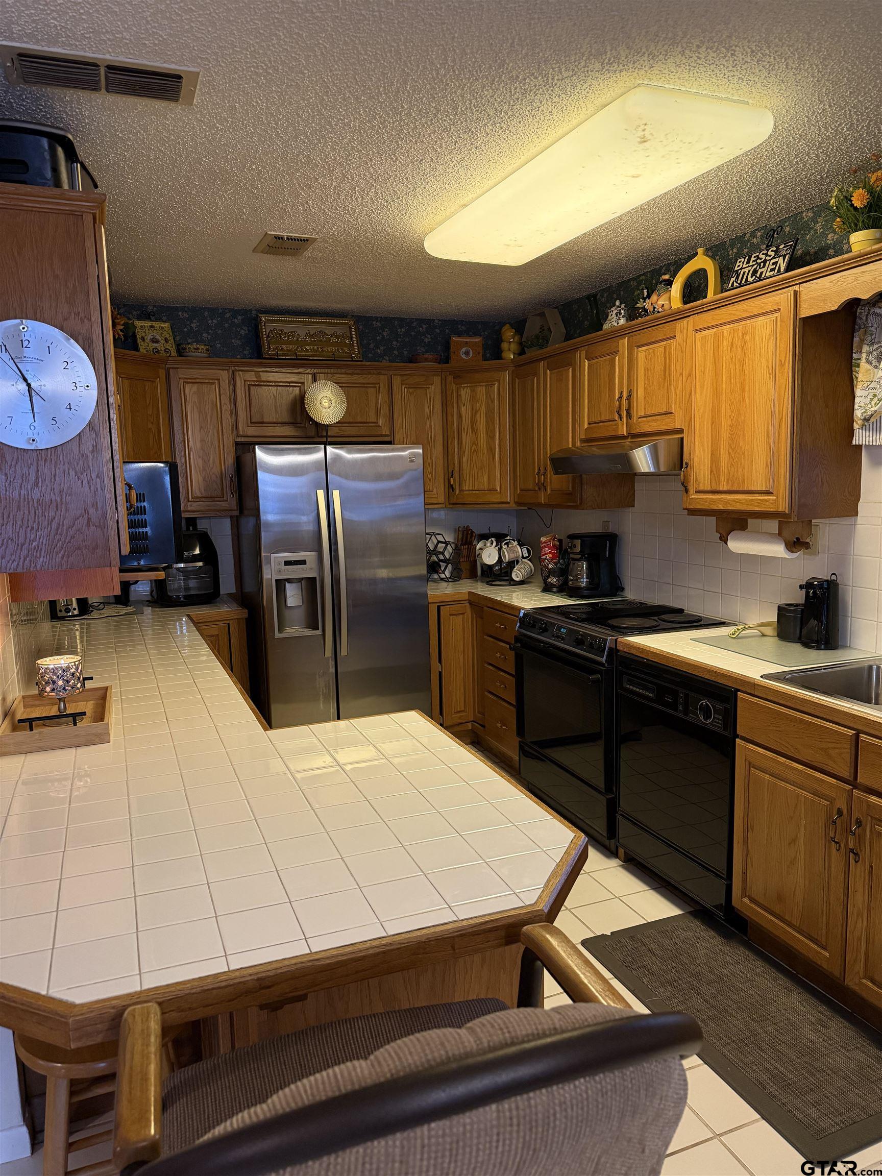 22571 Waterview Circle Flint, TX 75762 - Photo 24 of 41 a kitchen with kitchen island granite countertop a sink appliances and cabinets