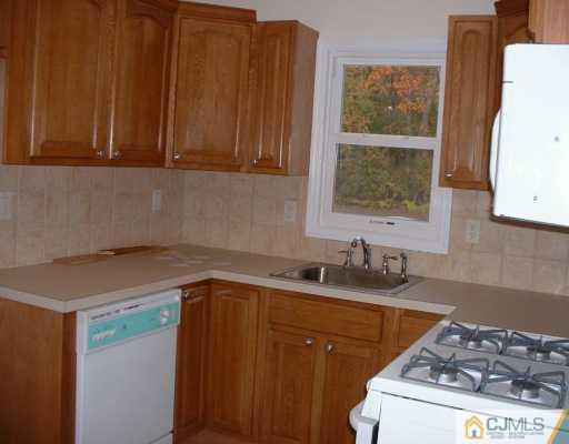 889 Englishtown Road Old Bridge, NJ 08857 - Photo 6 of 8 a kitchen with a sink and cabinets