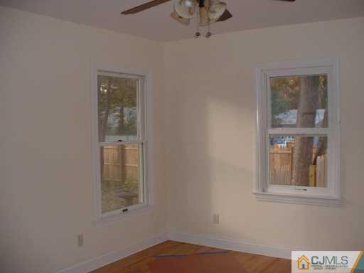 889 Englishtown Road Old Bridge, NJ 08857 - Photo 7 of 8 a view of an empty room with a window