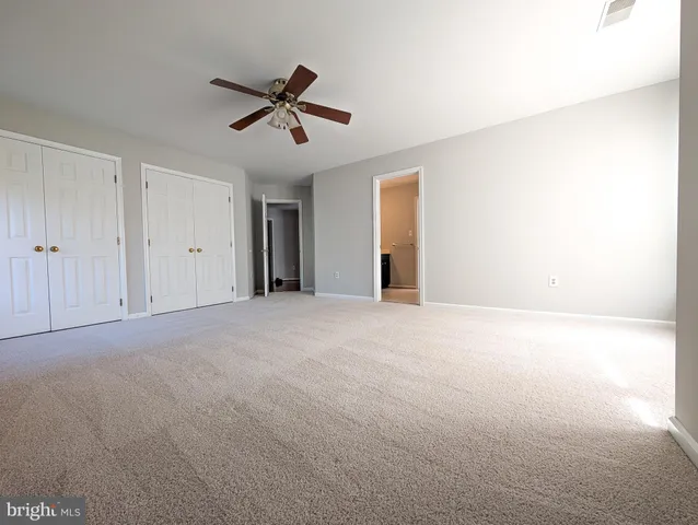 a view of a livingroom with a ceiling fan and window