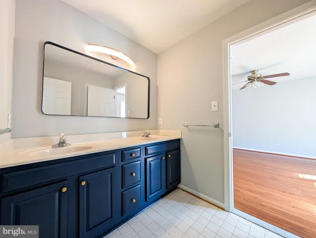 a bathroom with a double vanity sink and a mirror