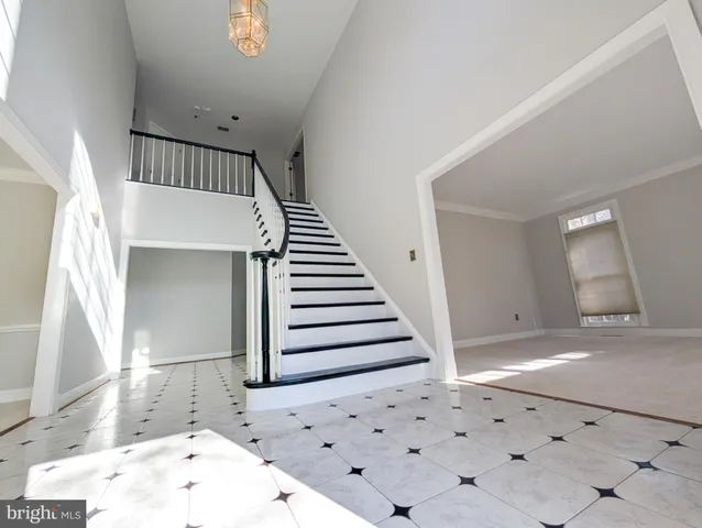 a view of a livingroom with wooden floor and stairs