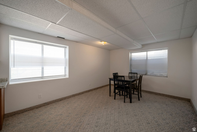 11922 Bluff View Drive Sandy, UT 84092 - Photo 22 of 30 Dining room with a drop ceiling, light carpet, and healthy amount of natural light