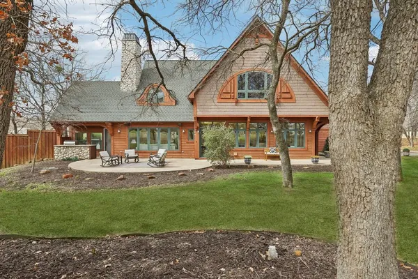 a view of a house with backyard and sitting area