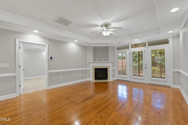 a view of an empty room with a fireplace and a window