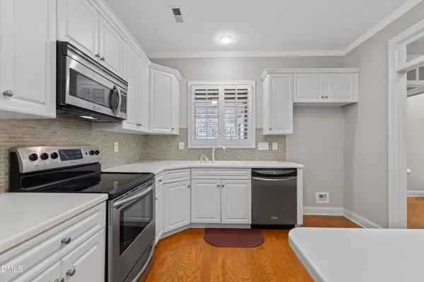 a kitchen with a sink stove and microwave
