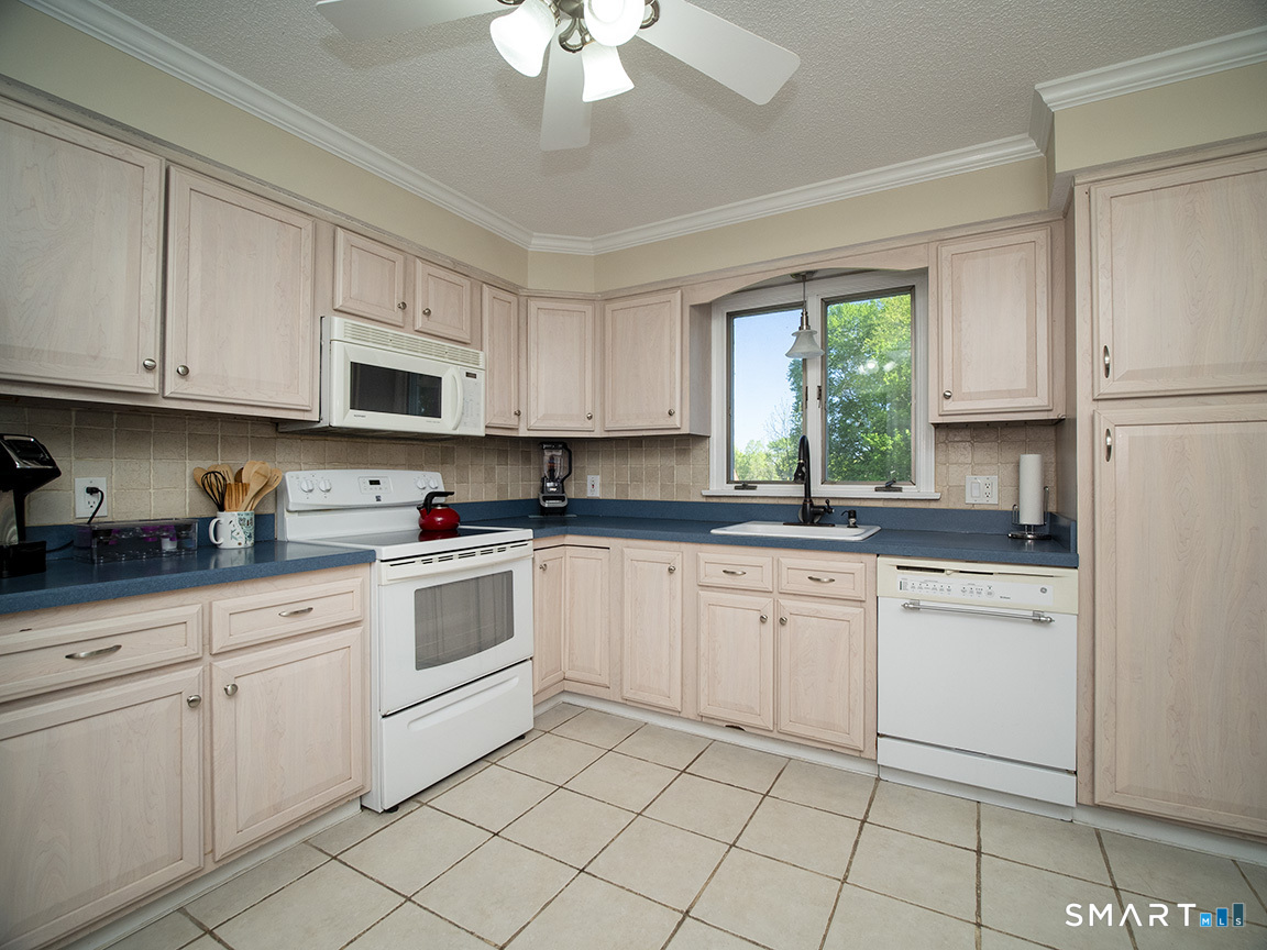 82 Wilcox Road Middletown, CT 06457 - Photo 18 of 27 a kitchen with cabinets appliances a sink and a window