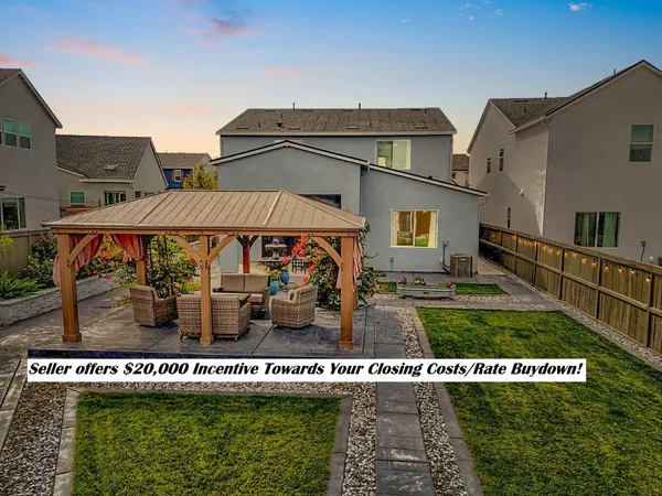 a view of a house with a yard from a fountain