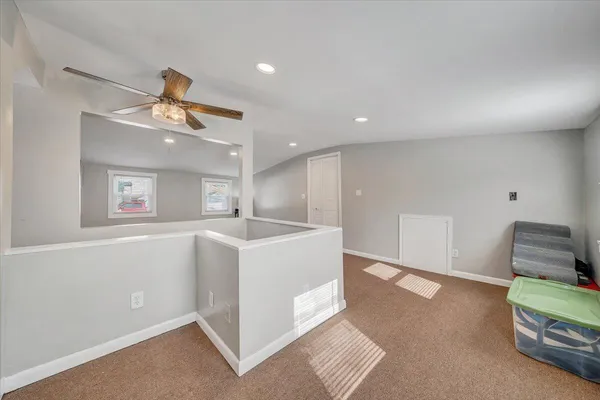 a view of kitchen with furniture and refrigerator