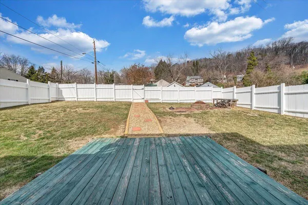 a view of a yard with wooden fence