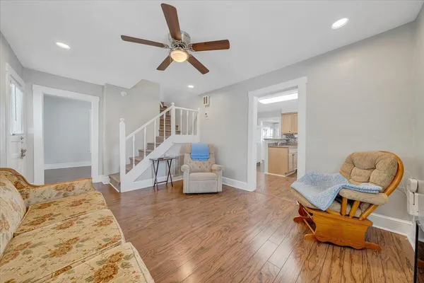a living room with furniture and a wooden floor