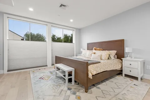 a bedroom with a large bed and a window