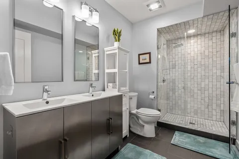 a bathroom with a sink toilet and shower