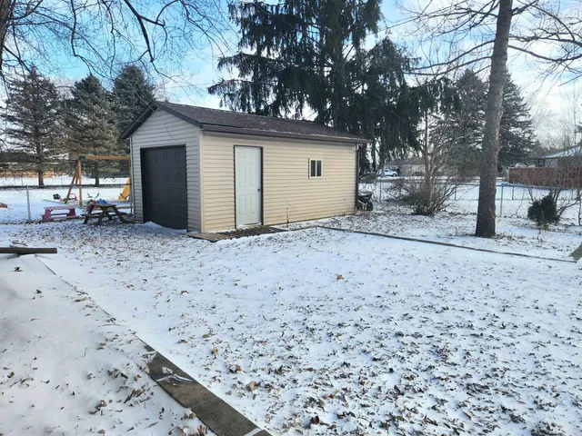 a view of a house with a snow in the yard