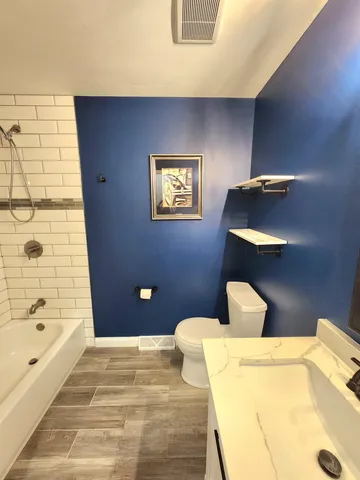 a bathroom with a toilet and a shower