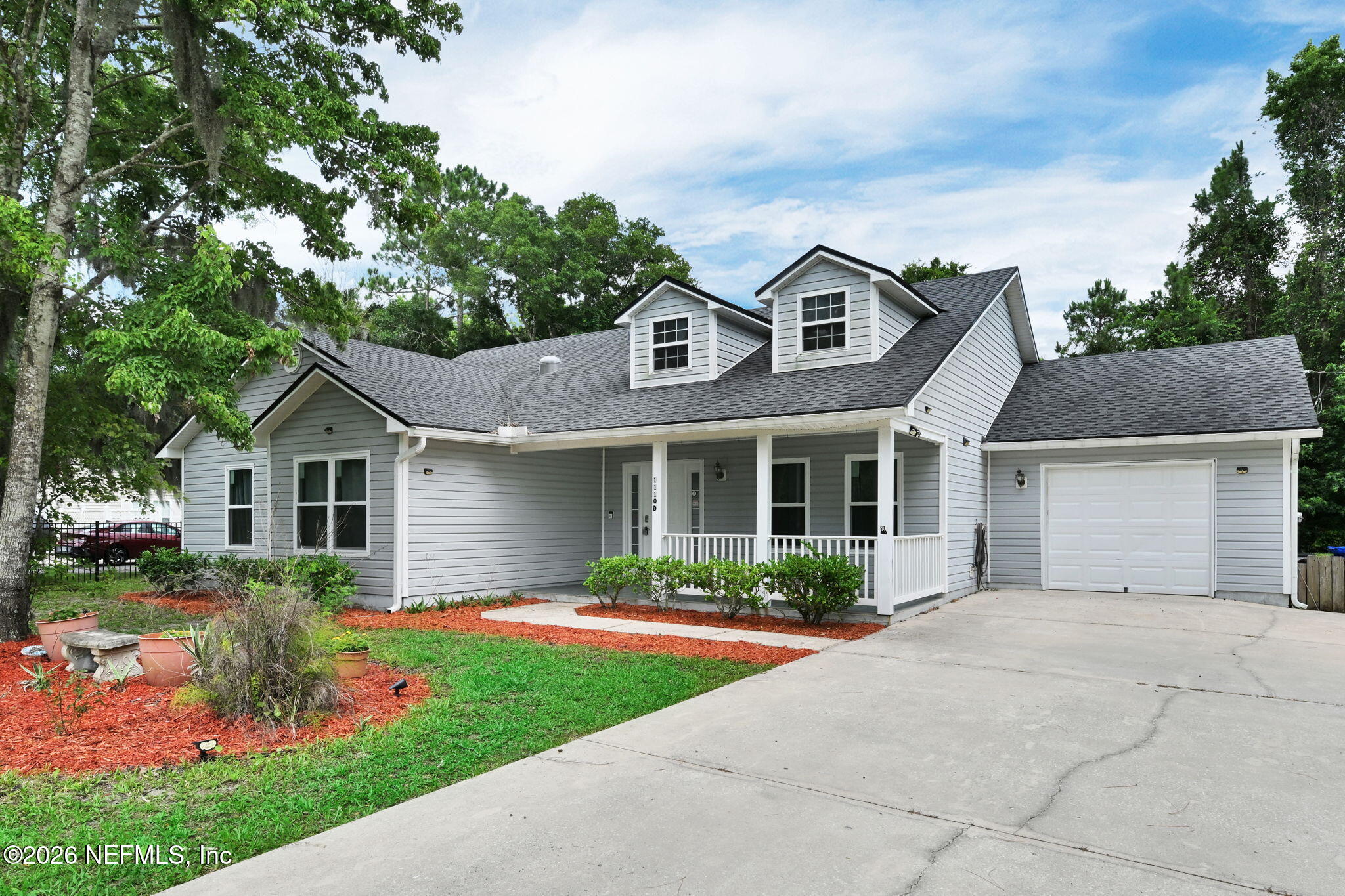 1110 Woodlawn Road, Unit D St. Augustine, FL 32084 - Photo 5 of 40 a front view of a house with a garden and plants
