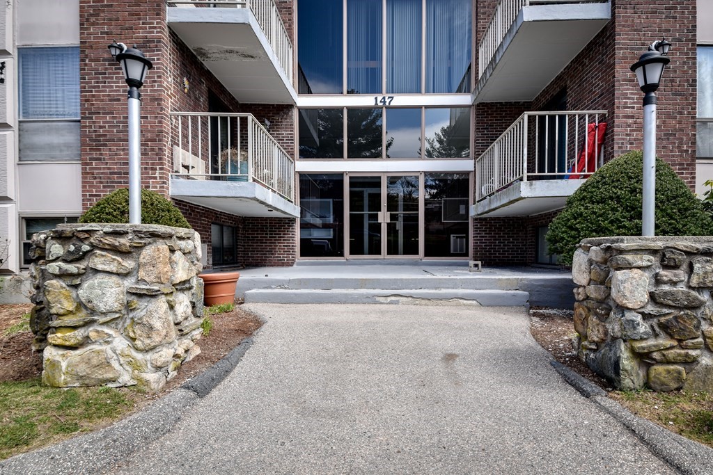147 Turner Road, Unit 96 Holliston, MA 01746 - Photo 1 of 14 a front view of a house with a garage